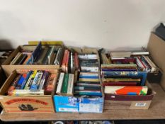 Five boxes of hardback and paperback books,