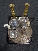 A tray of heavy brass candlesticks, two plated serving trays,