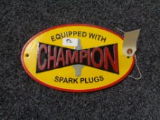 A metal Champions Spark plugs plaque