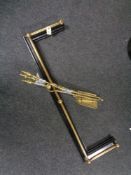 An antique brass cast iron fire curb together with three brass companion pieces