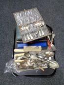 A tray of boxed and unboxed cutlery