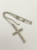 An 18ct white gold diamond set cross on chain CONDITION REPORT: Cross dimensions