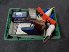 A crate of cribbage board, vintage ice skates, etc,