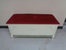 A blanket box with red dralon seat
