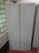 A metal double door stationary cupboard