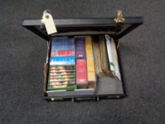 A leather briefcase containing first day cover stamps,