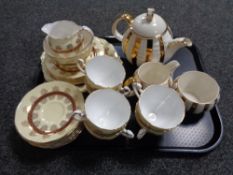 A tray of teapot sugar basin and milk jug together with a twenty one piece Roslyn tea service