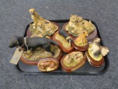 A tray of animal figures on wooden bases,