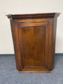 A Georgian oak corner cabinet with astragal glazed door