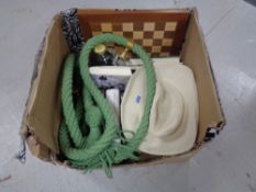 A box of hardbacked books, novels, length of rope, chess board,