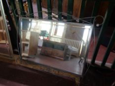 A metal framed bevelled mirror