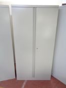 A metal double door stationary cupboard