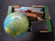 A box of miscellany including wooden candlesticks, 20th century globe, gent's travel set,