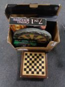 A chessboard with pieces, poker set, roulette wheel,