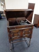 An early 20th century gramophone in oak cabinet by The Minstrel and a box of 78's