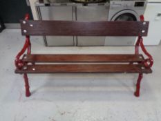 A cast iron wooden slatted garden bench