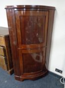 An early twentieth century mahogany double corner cabinet