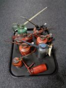 A tray of seven vintage oil cans