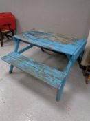 A wooden picnic table with benches