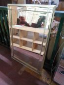 A silvered framed bevelled sectional mirror
