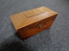 A 19th century mahogany tea caddy with key