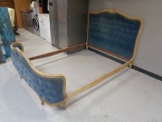 An early 20th century 5' bed frame in blue button dralon