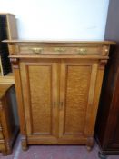 An early 20th century double door cabinet fitted a drawer