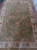 A machine made floral woolen carpet on green ground