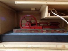 A scratch built plastic model of an engine in wooden crate