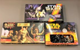 A collection of Star Wars games including Star Wars Saga Edition Monopoly,