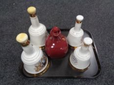 A tray of four Bells Scotch whisky decanters (one with contents unsealed) and one further decanter