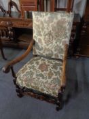 A carved oak scroll arm armchair in tapestry fabric