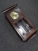 An early 20th century oak cased wall clock with brass and silvered dial,