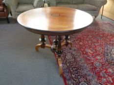 A continental mahogany and ebonised circular dining table