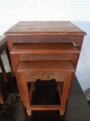 A nest of three carved oriental style tables