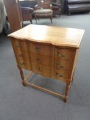 A blonde oak three drawer chest