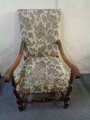A 20th century carved oak scroll arm armchair