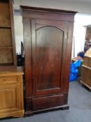 An antique pine single door wardrobe