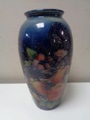 A Moorcroft vase of pomegranate and bird design, height 25 cm.