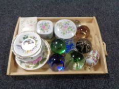 A tray of glass paperweights, china trinket boxes,
