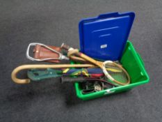 A box of sports rackets, football boots, parasol,
