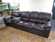 A brown leather three seater settee and matching armchair