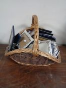 A wicker hand basket and quantity of assorted photograph frames