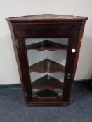 A nineteenth century oak glazed corner cabinet