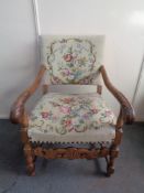 A 20th century carved oak scroll arm armchair