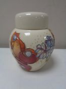 A Moorcroft lidded ginger jar, decorated with butterflies on cream ground, height 11 cm.