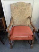 A 20th century carved oak scroll arm armchair