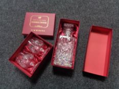 A boxed Bohemian crystal pin wheel decanter and two further boxed brandy glasses.