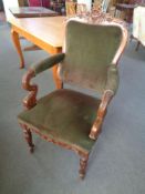 An antique carved mahogany armchair