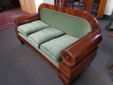 An antique mahogany framed hall settee in green dralon